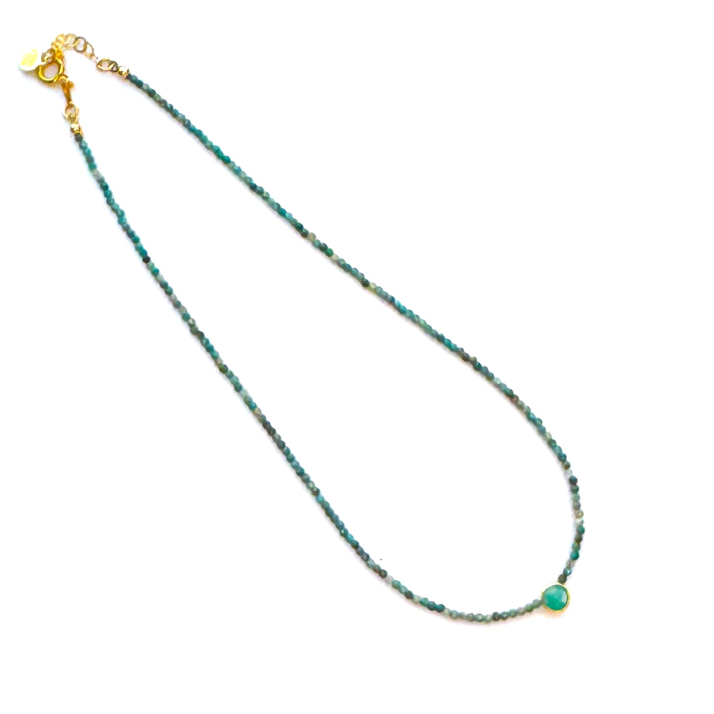 Necklace with green beads on a white background