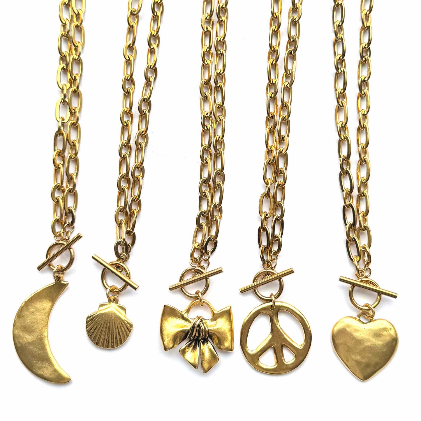 Set of five gold necklaces with various pendants on a white background