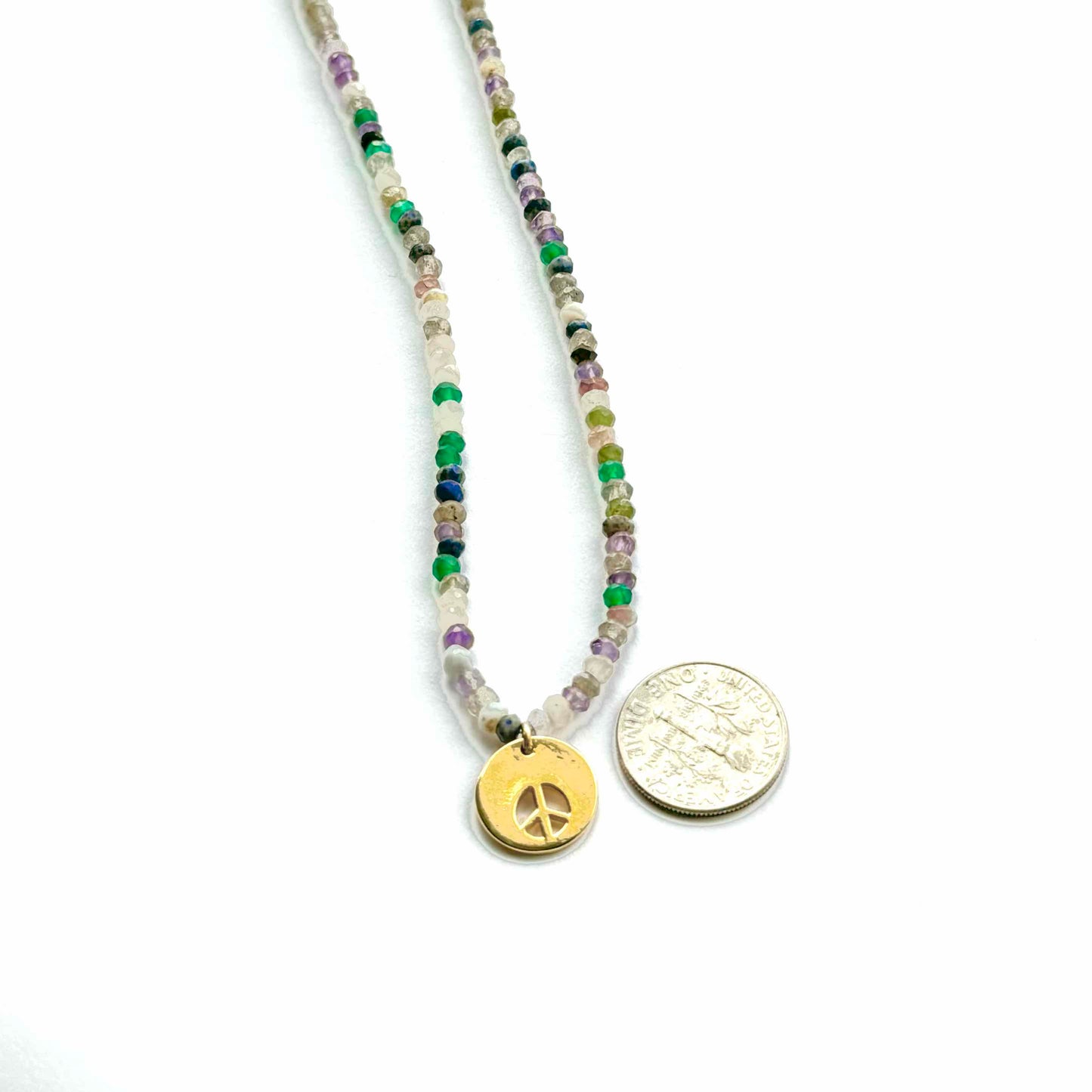 Necklace with peace sign charm on a white background