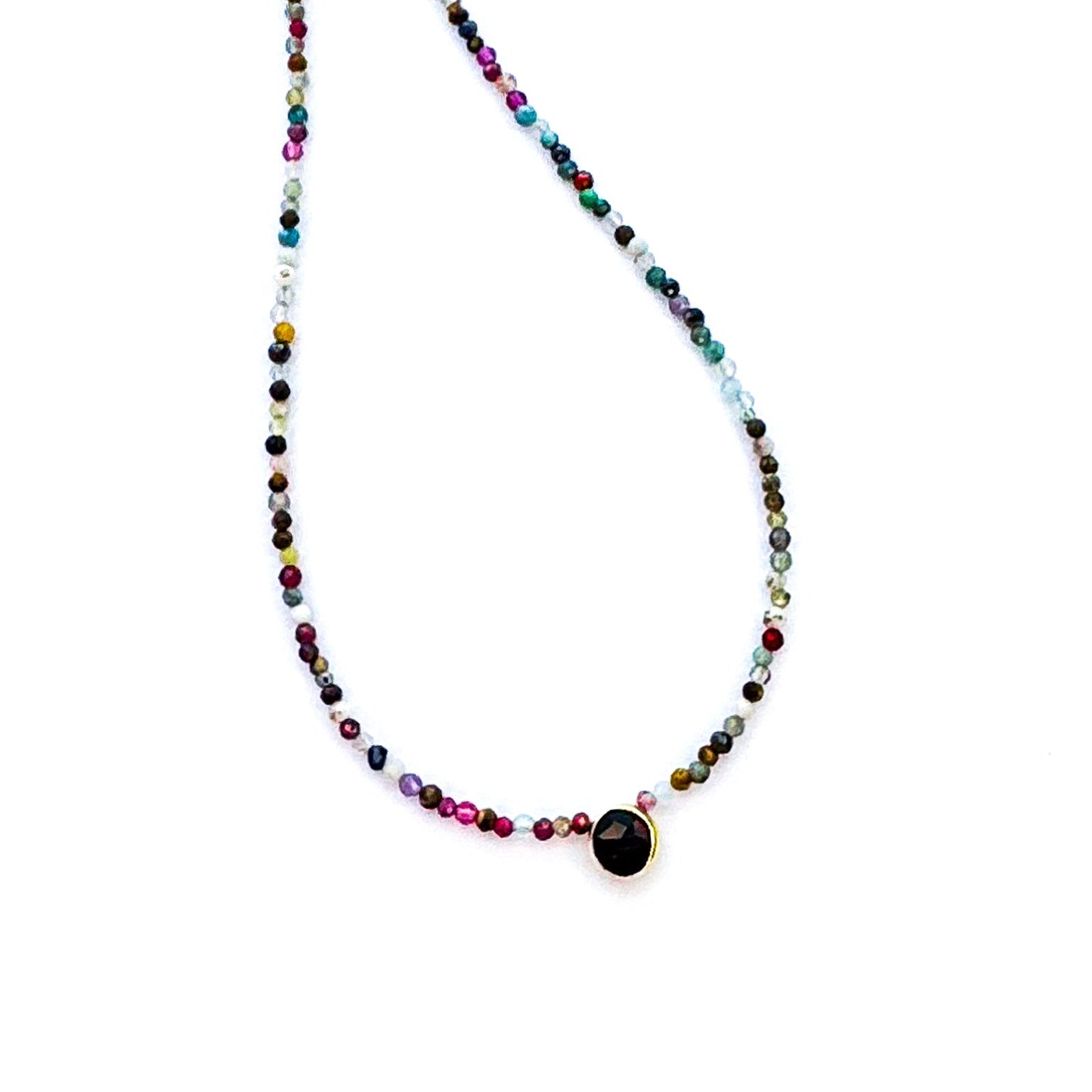 Multicolored beaded necklace with a black pendant on a white background