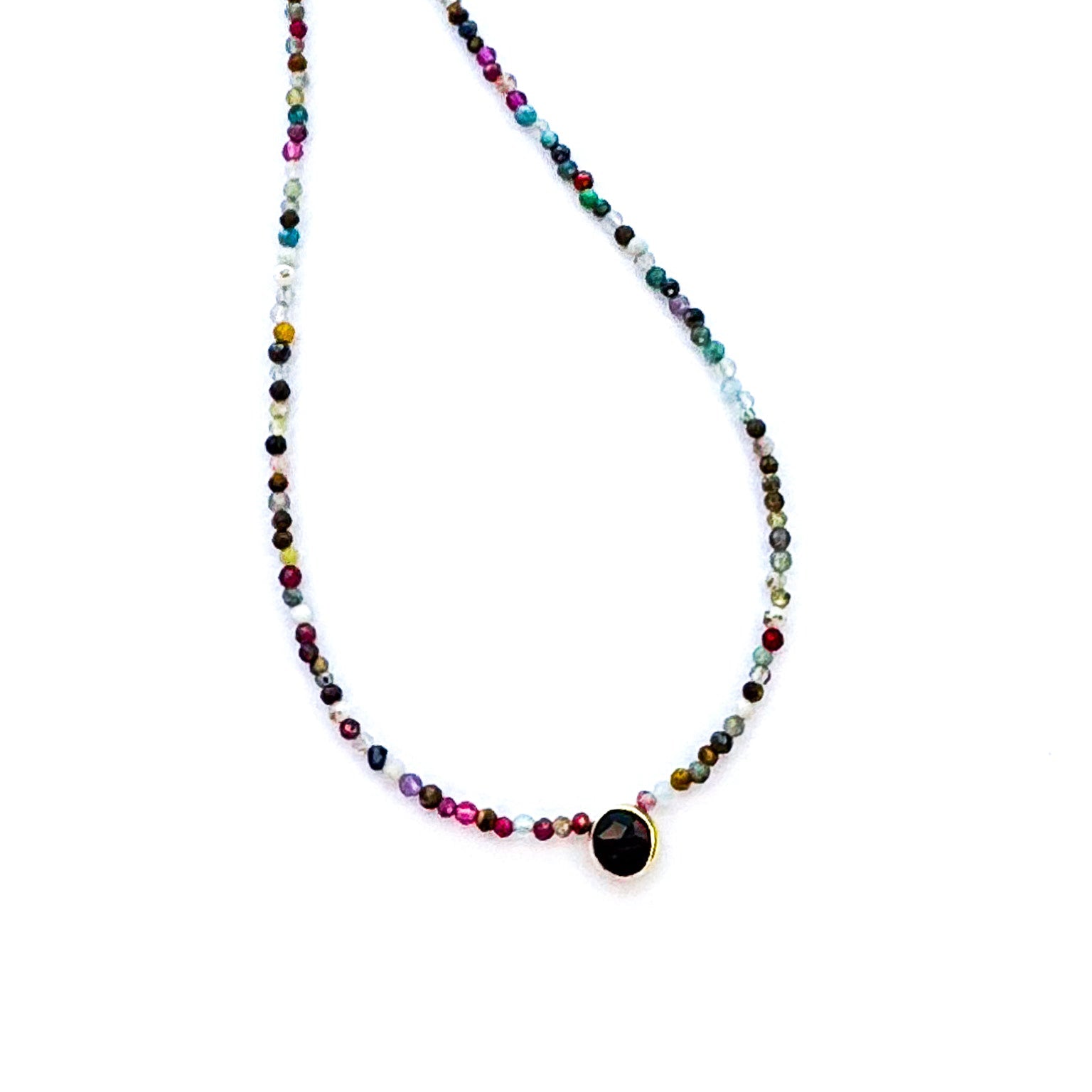 Multicolored beaded necklace with a black pendant on a white background