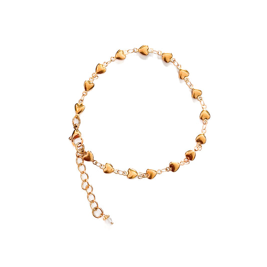 Gold heart-shaped anklet on a white background