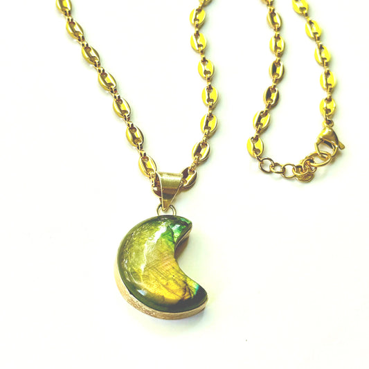 Gold necklace with a labradorite moon pendant on a white background