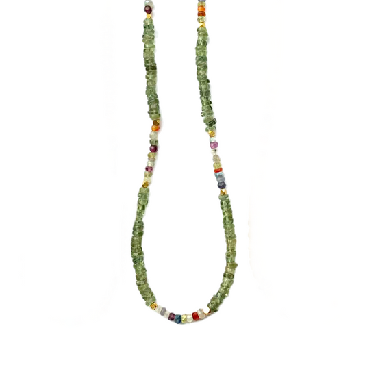 Necklace with green beads and multicolored accents on a white background