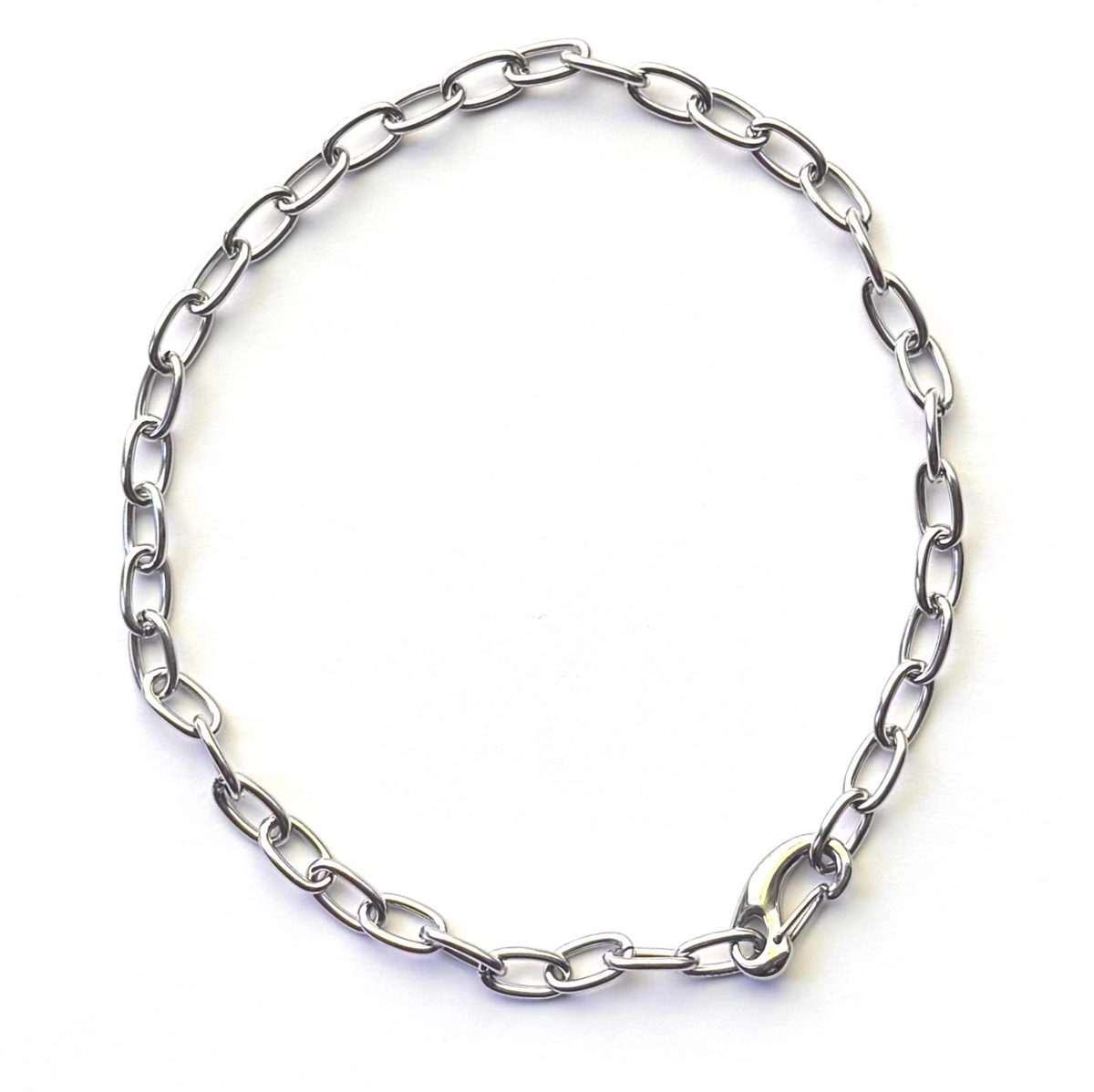 A silver-toned metal chain necklace with elongated oval links and a polished clasp, photographed on a plain white background.