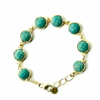 Turquoise beaded bracelet with gold chain on a white background