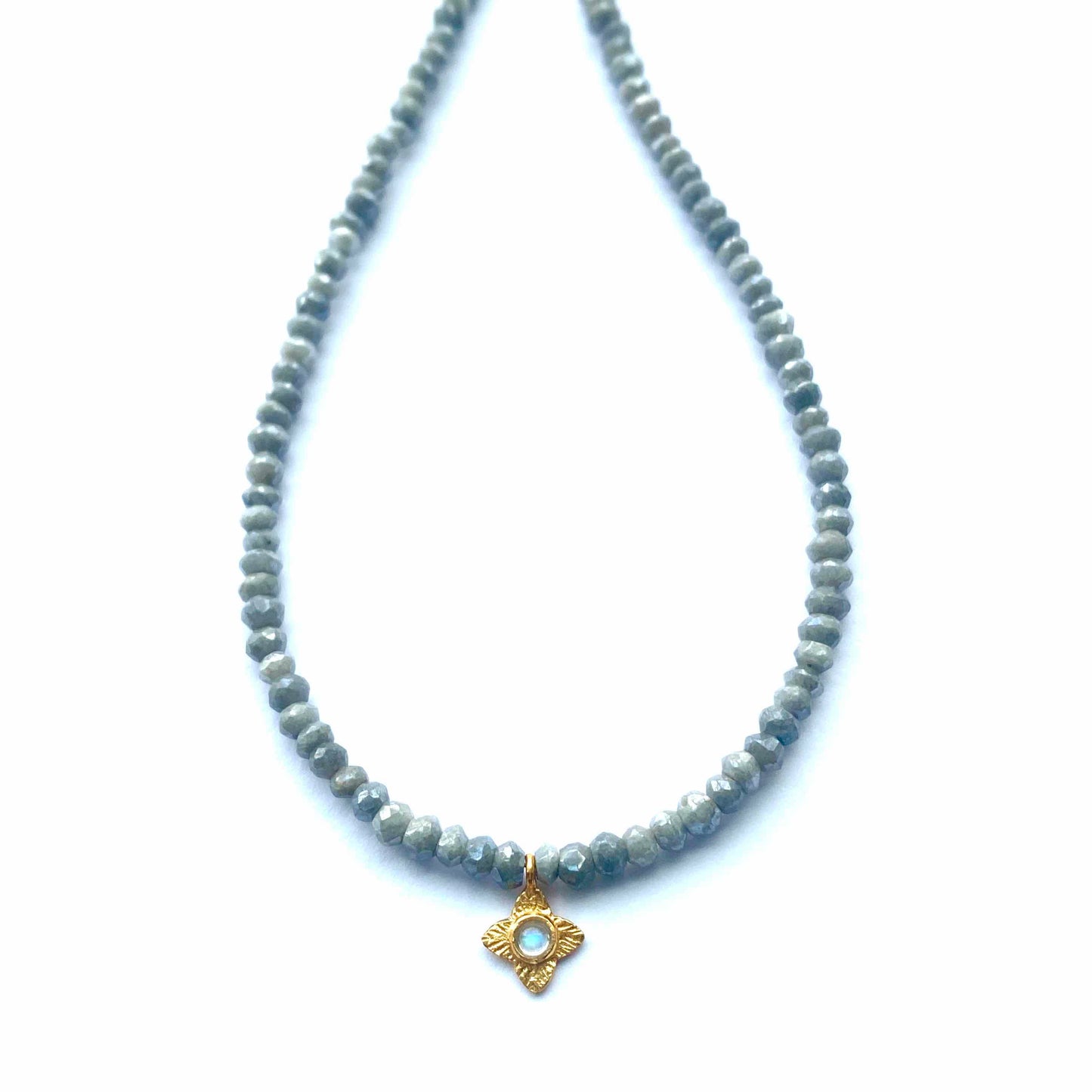 Necklace with gray beads and a gold pendant on a white background