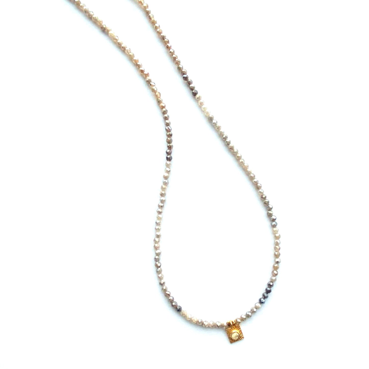 Necklace with small square pendant on a white background