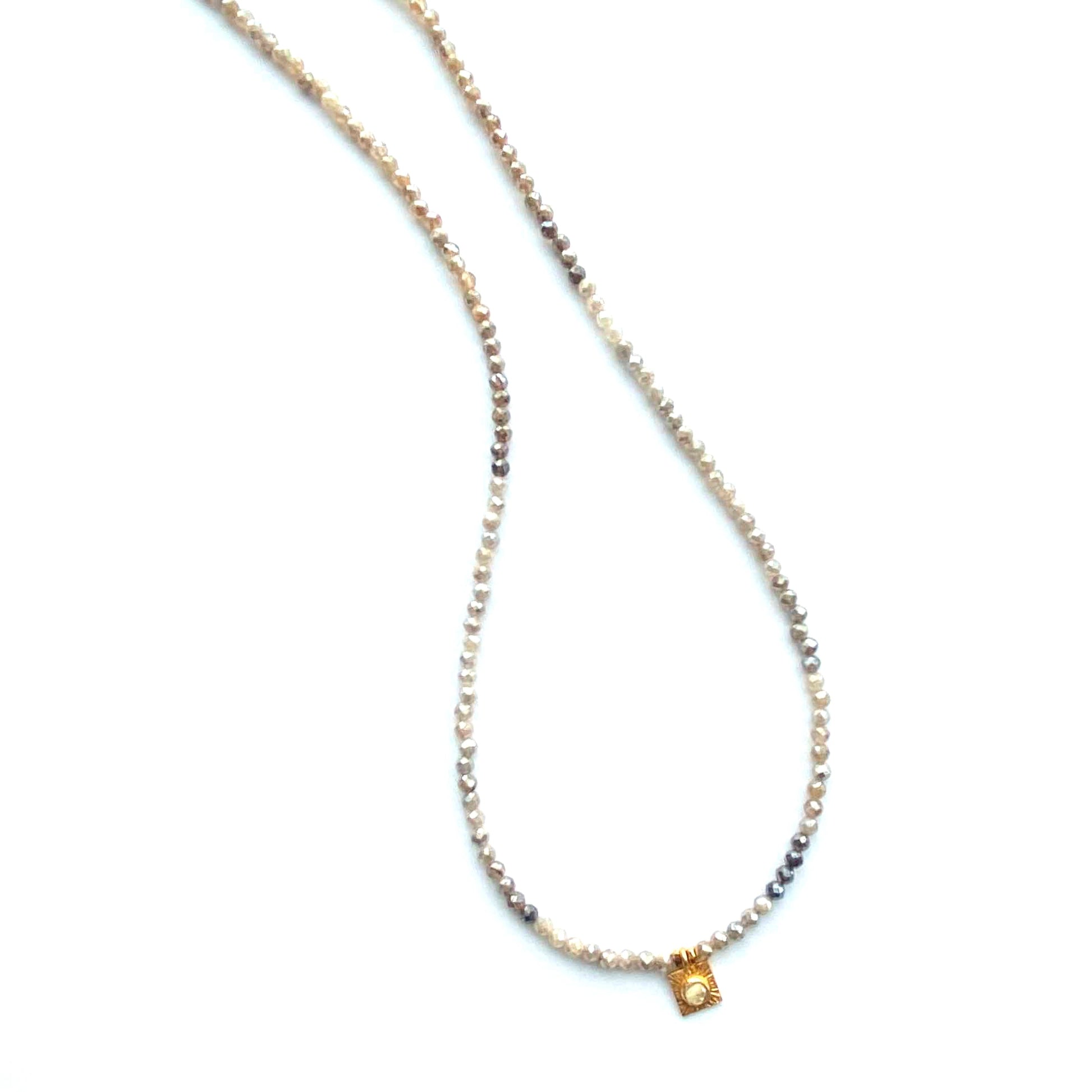 Necklace with small square pendant on a white background