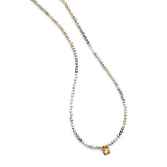 Necklace with small square pendant on a white background