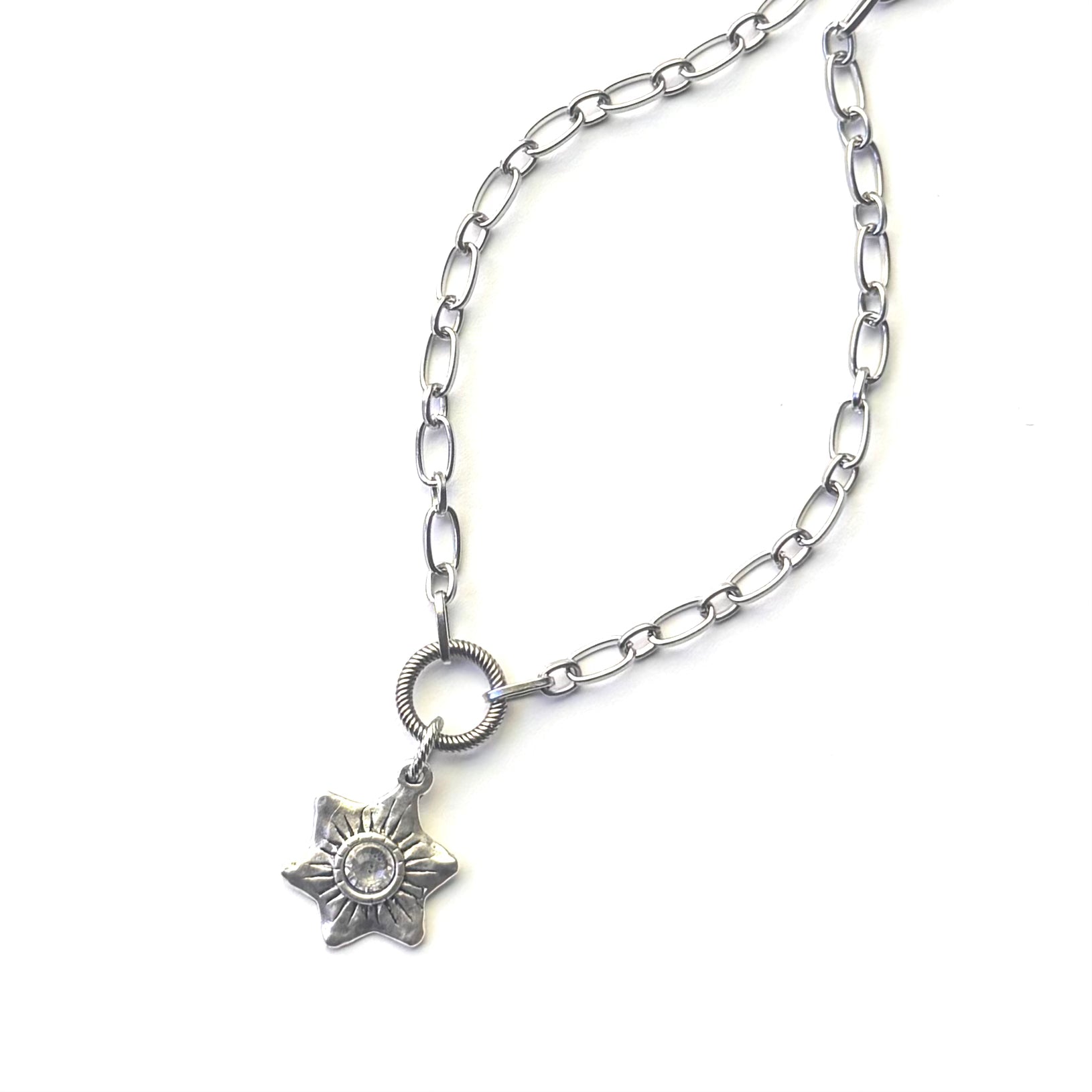 A silver-toned chain necklace featuring a six-pointed star pendant with a clear central gemstone, displayed on a clean white background.