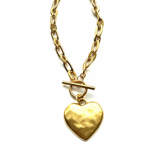 Gold heart pendant necklace on a white background