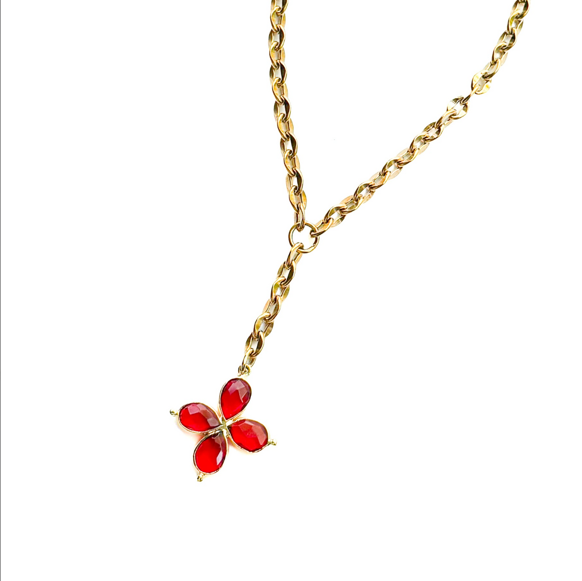 A yellow gold Y-shaped lariat necklace featuring a four-petal flower pendant with red stones, set against a plain white background.