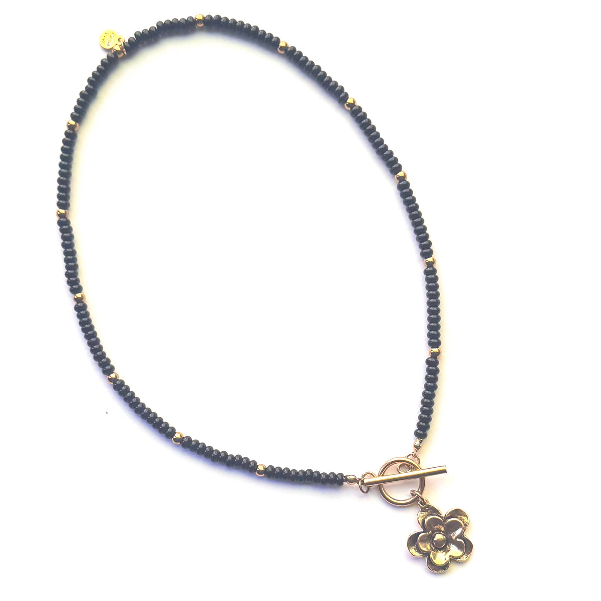 onyx beaded necklace with gold toned flower pendent with toggle closer.