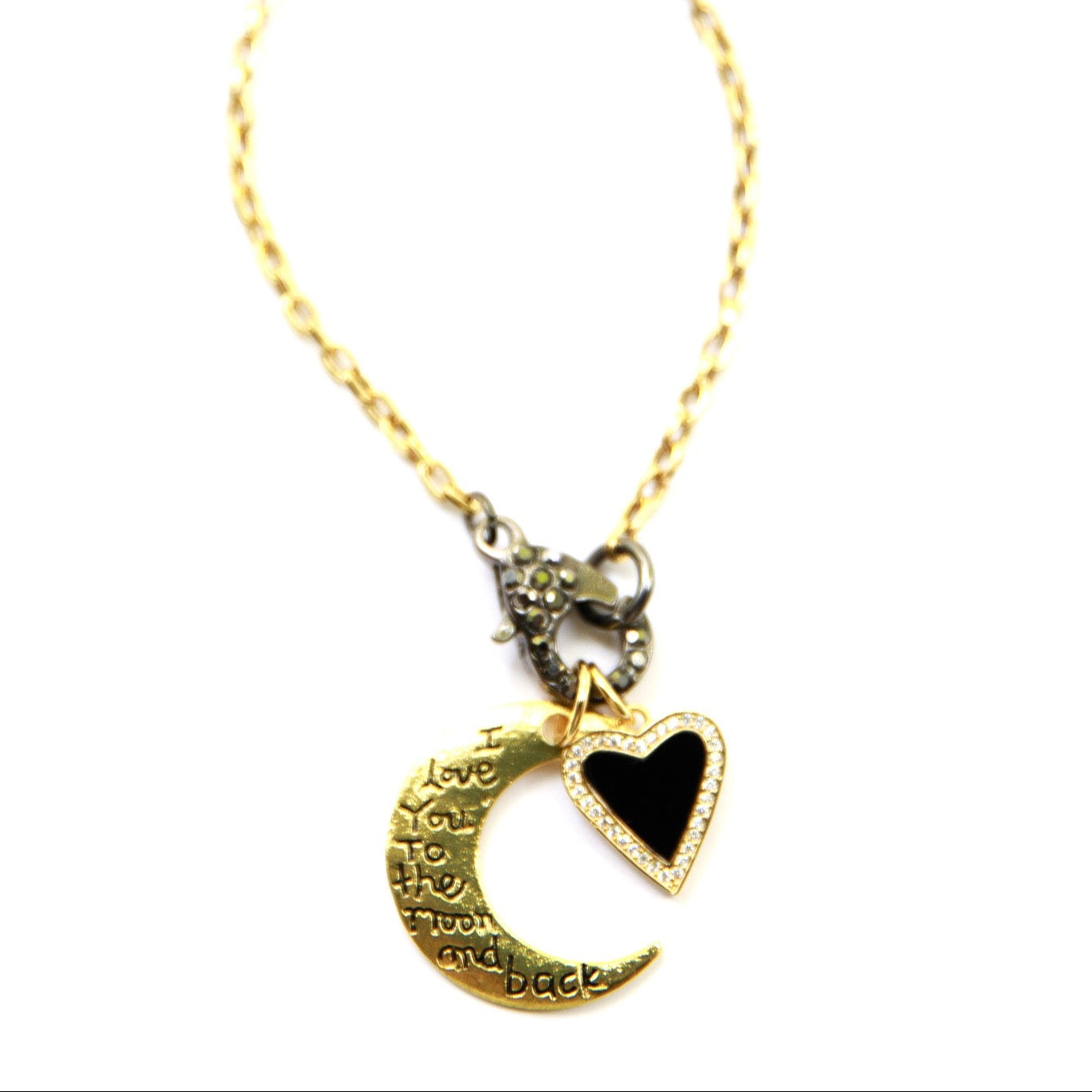 Gold necklace with a heart and moon pendant on a white background