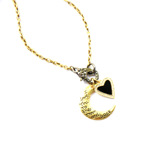 Gold necklace with moon and heart pendant on a white background