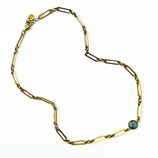 A vintage gold-toned paperclip chain necklace with a small round blue-green stone accent, displayed on a clean white background.