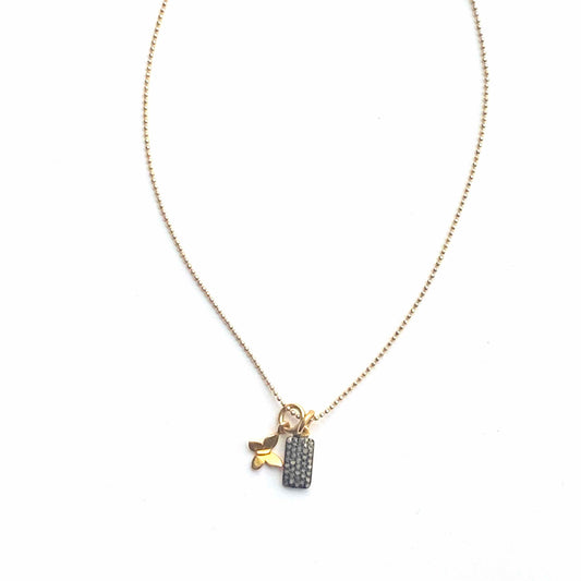 Gold necklace with a pendant on a white background
