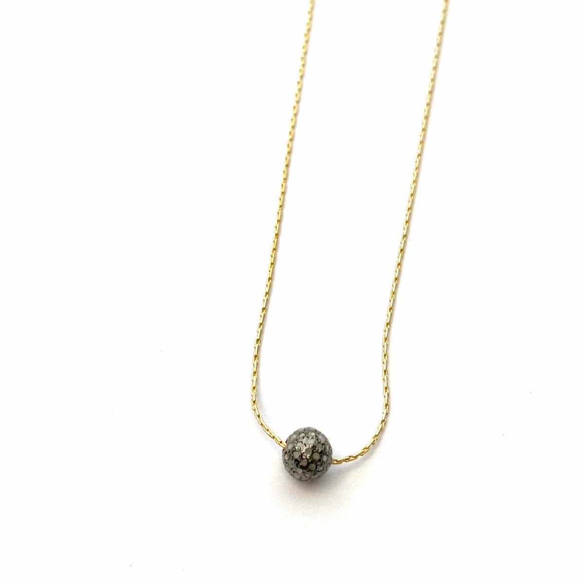 Gold chain necklace with diamond ball bead in center.