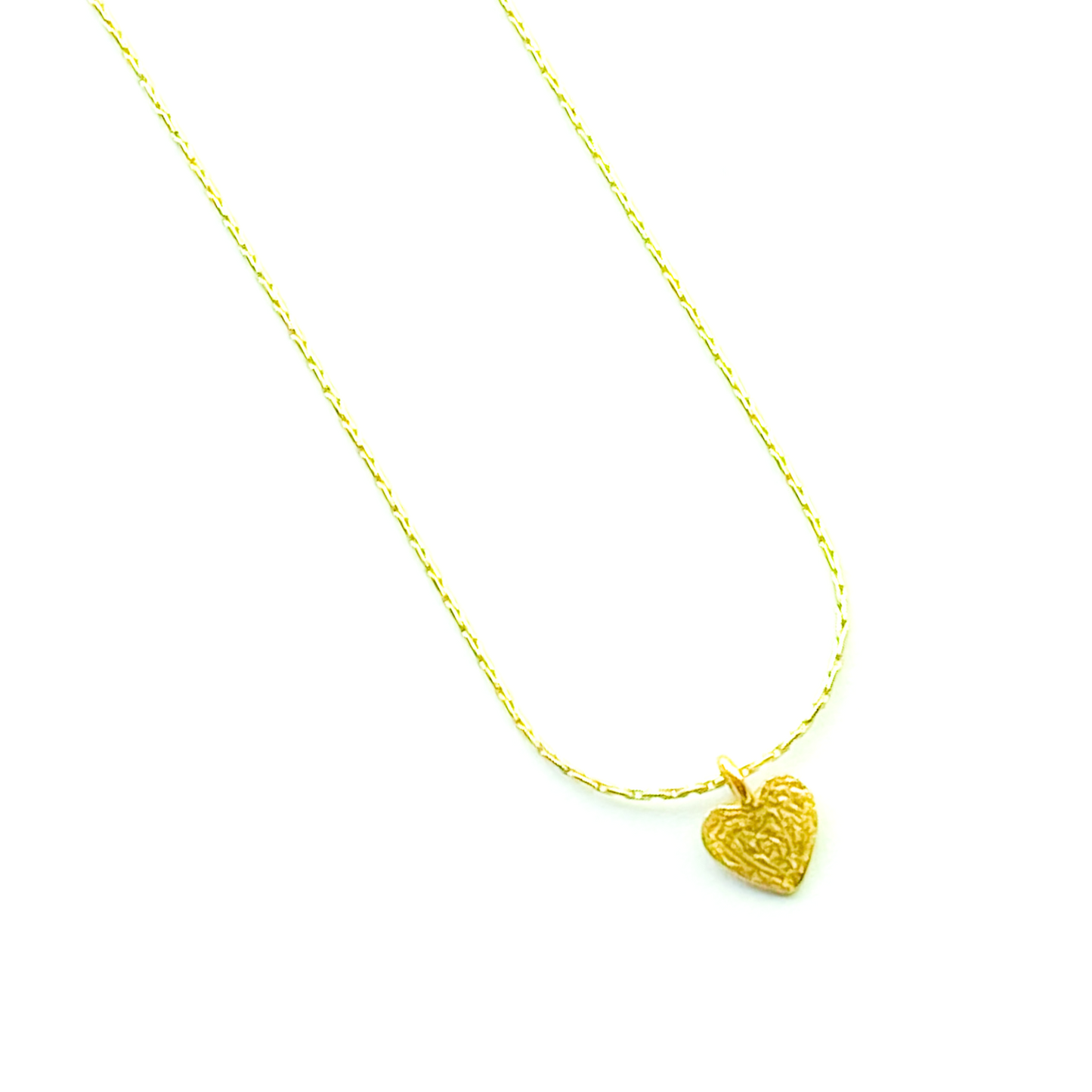 Gold heart-shaped pendant necklace on a white background