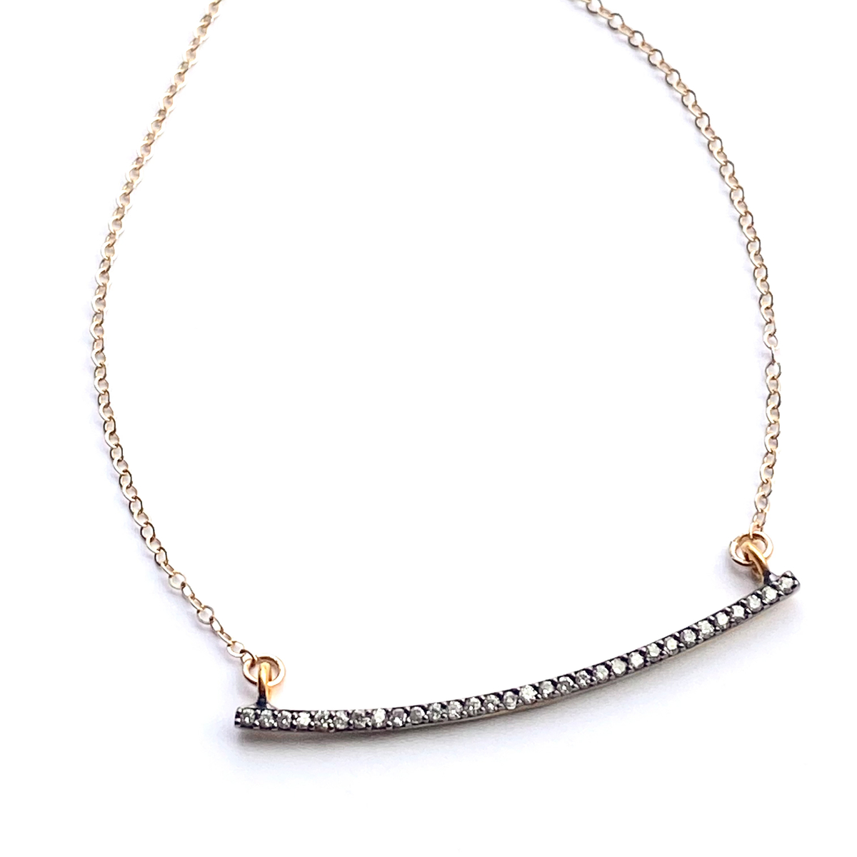 Gold and silver bar necklace on a white background