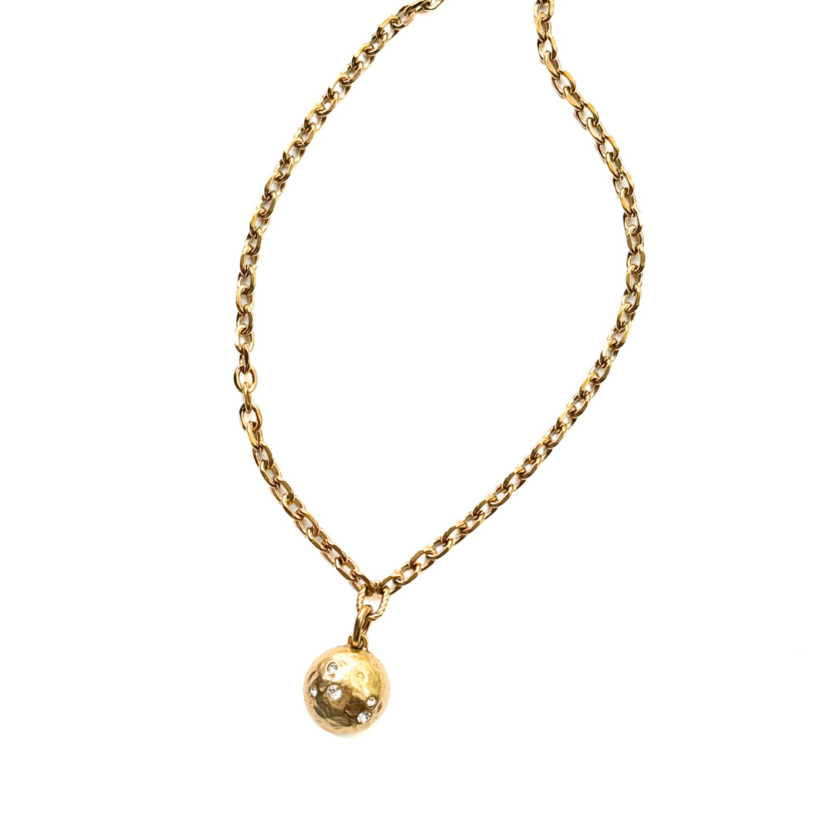 A gold chain necklace with a small, textured gold ball pendant, photographed against a solid white background.