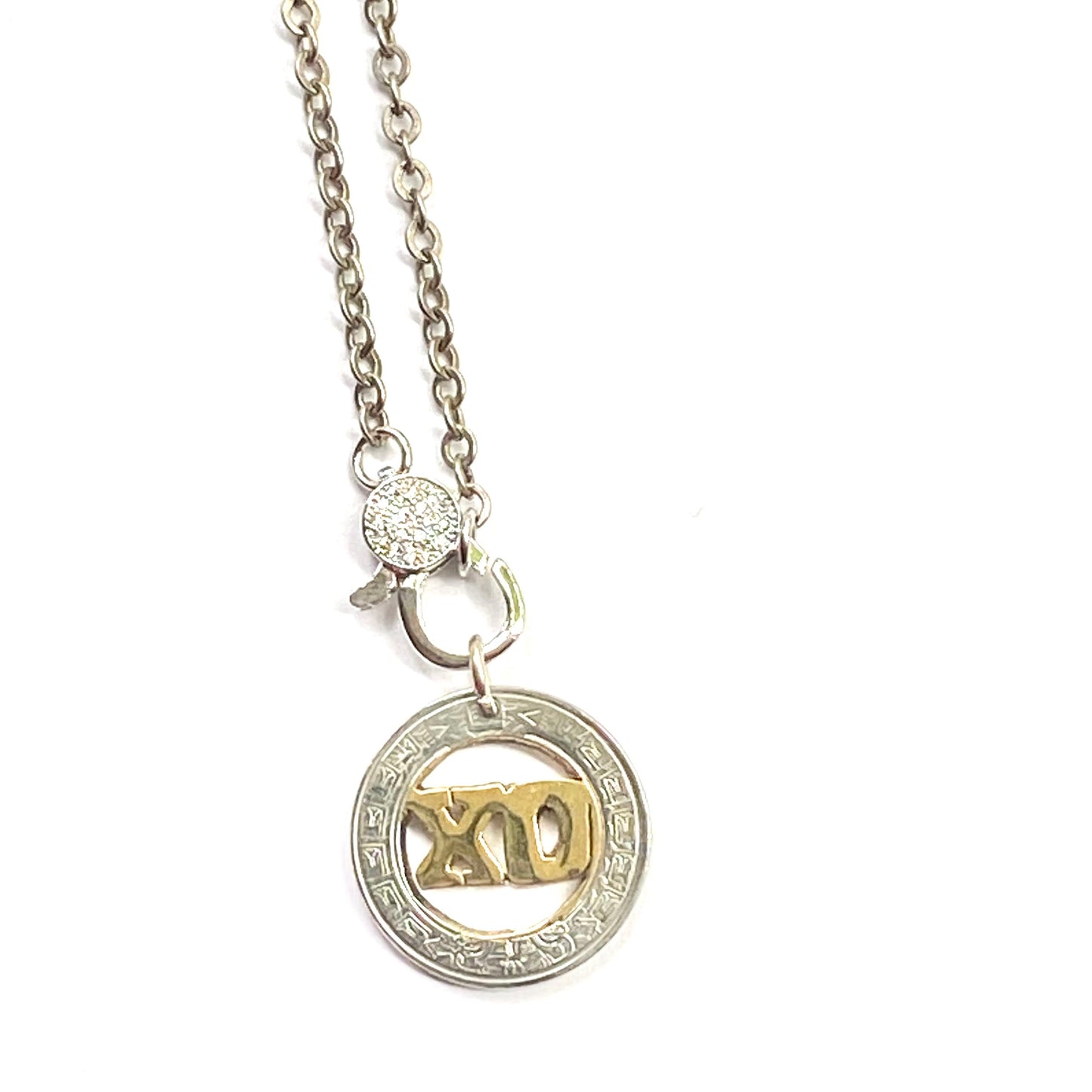 Necklace with a circular pendant featuring a design on a white background