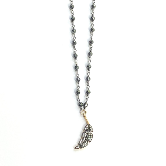 Necklace with a feather pendant on a white background