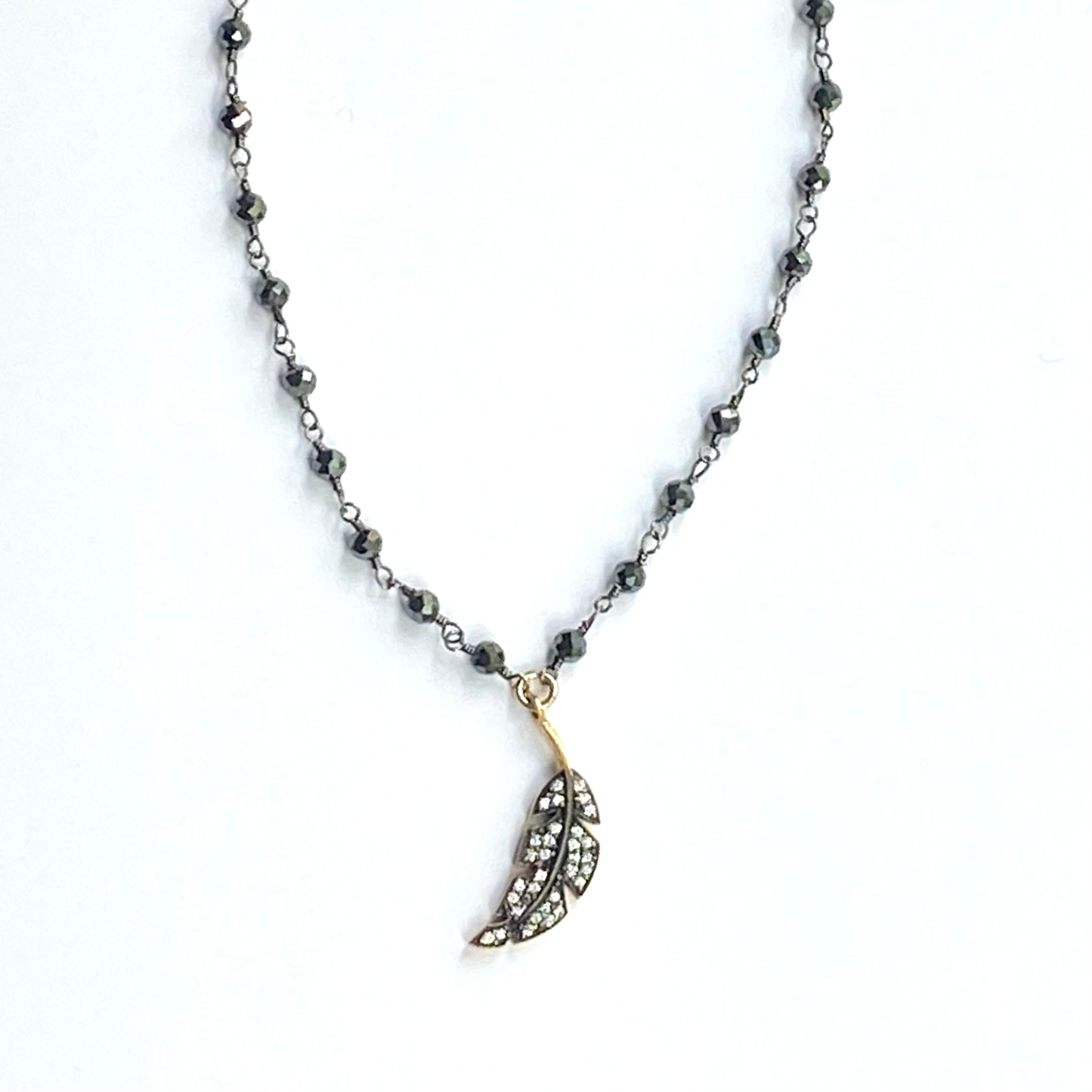 Necklace with a leaf-shaped pendant on a white background