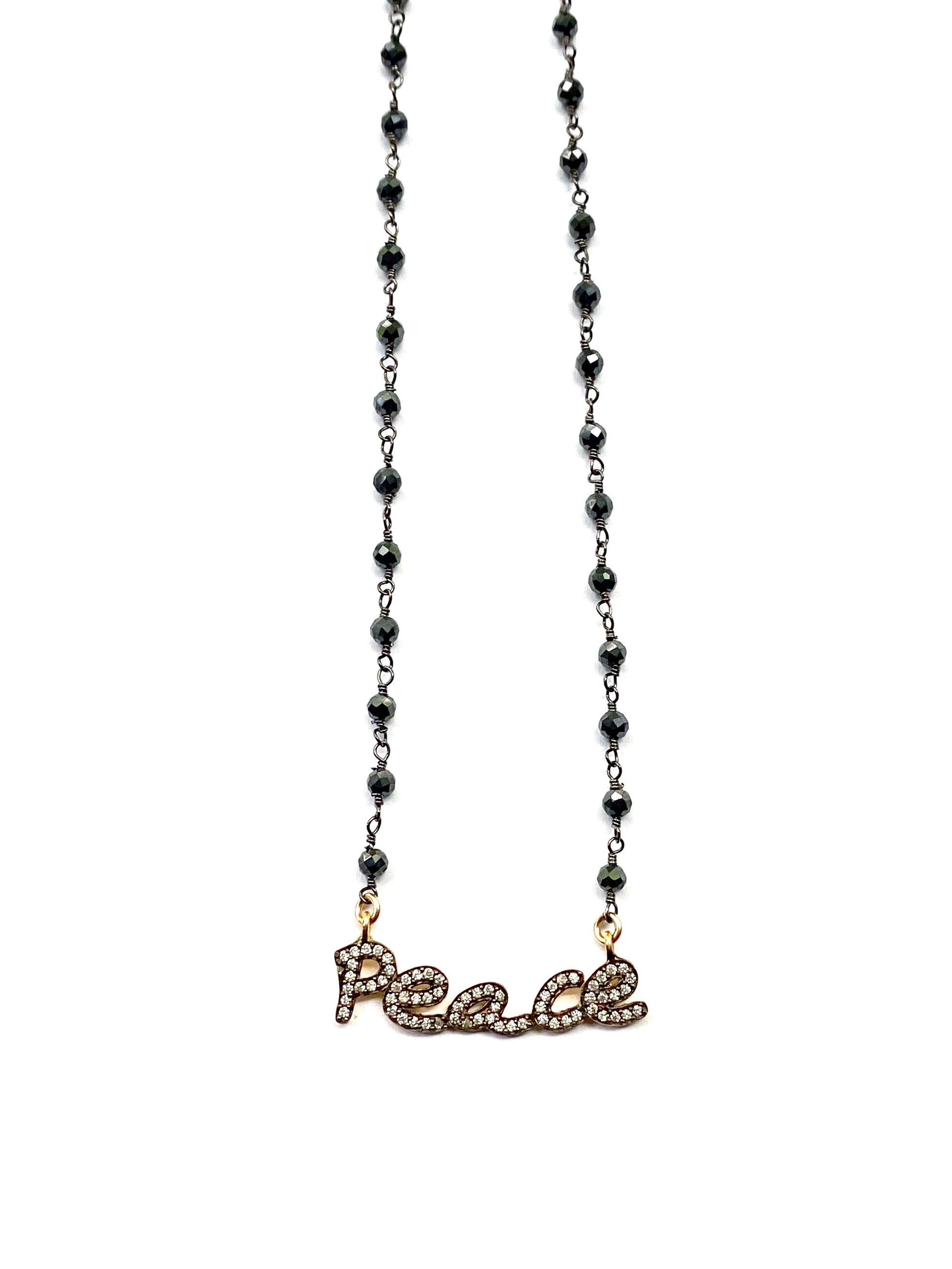 Necklace with 'peace' pendant on a white background