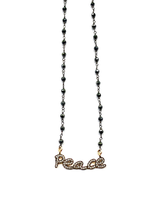 Necklace with 'peace' pendant on a white background