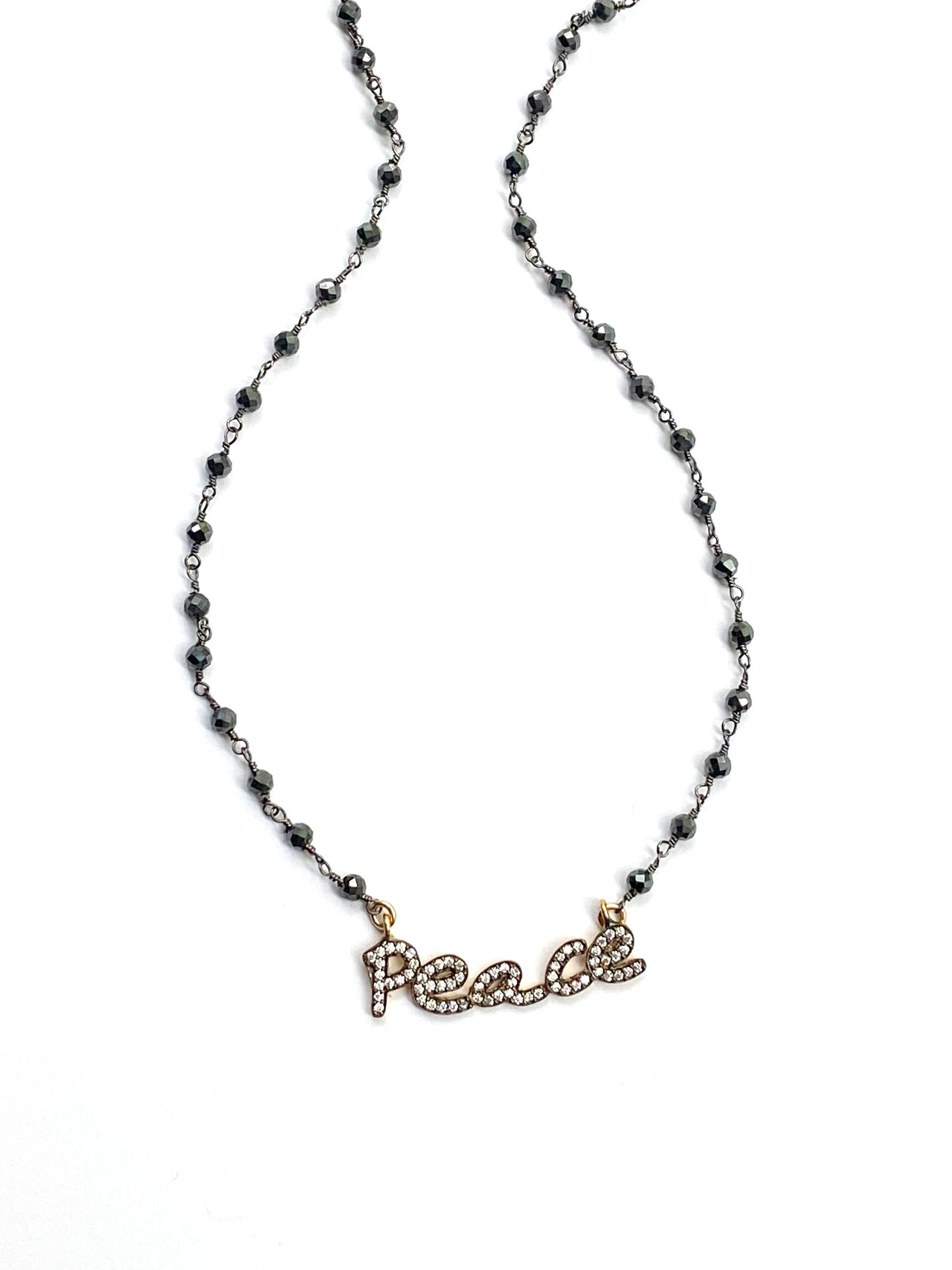 Necklace with 'PEACE' pendant on a white background