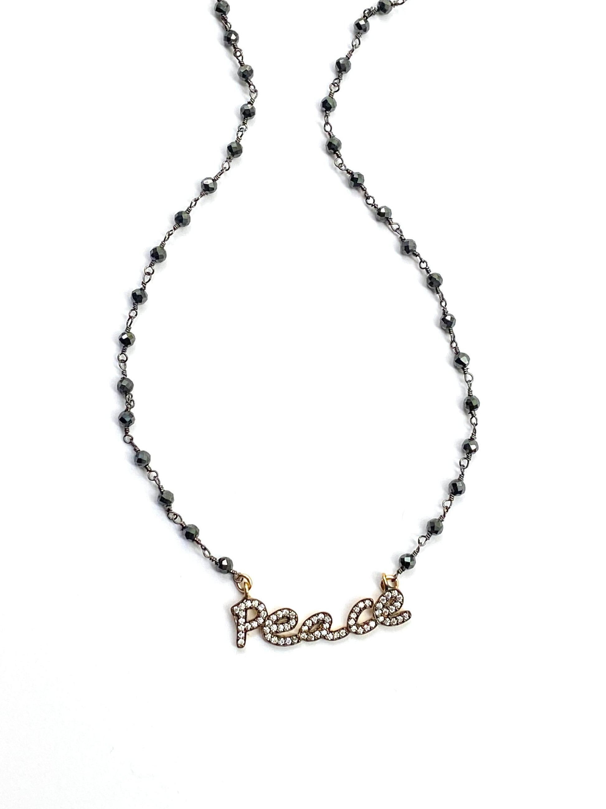 Necklace with 'PEACE' pendant on a white background