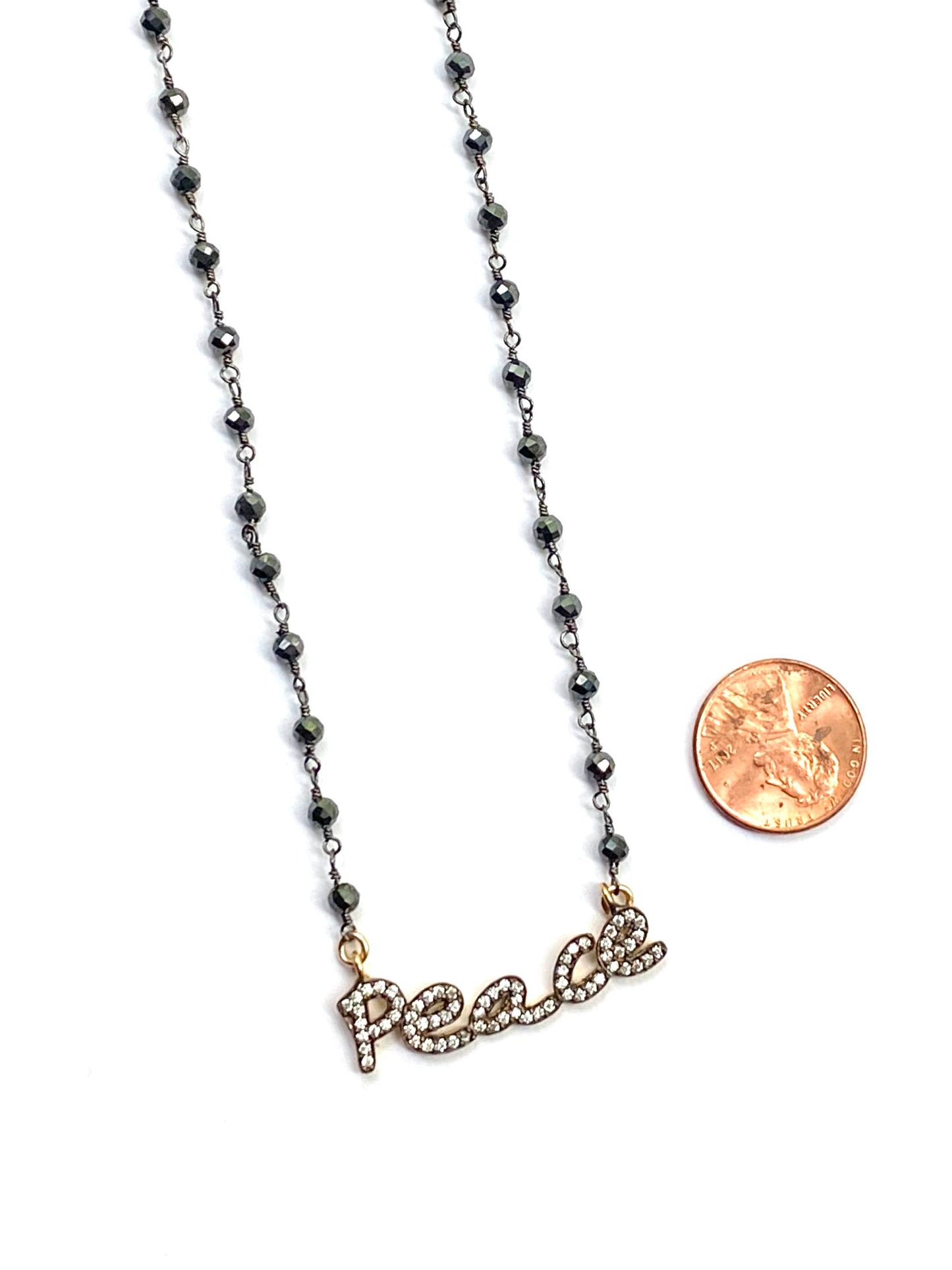 Necklace with 'peace' pendant on a white background