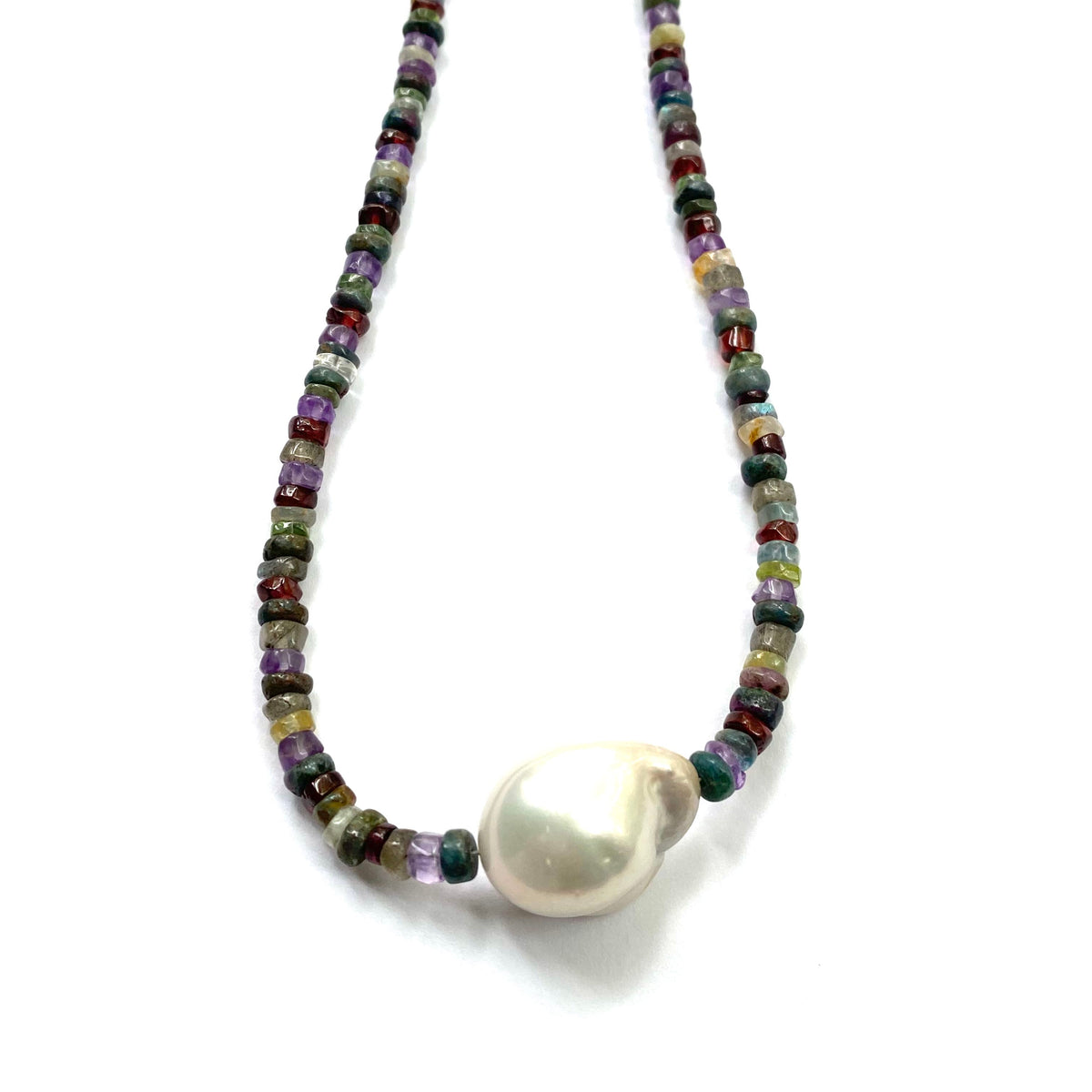 Necklace with multicolored beads and a large white pearl on a white background