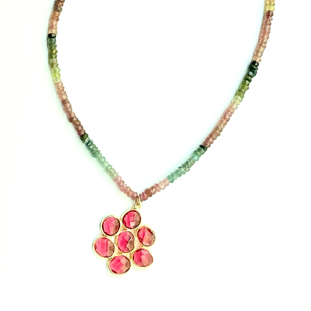 Necklace with multicolored beads and a pink pendant on a white background